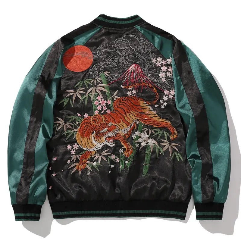 Black anime-inspired jacket with intricate embroidery of a fierce, mythical warrior in red and gray tones.